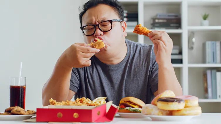 A man tucks in to fast food.