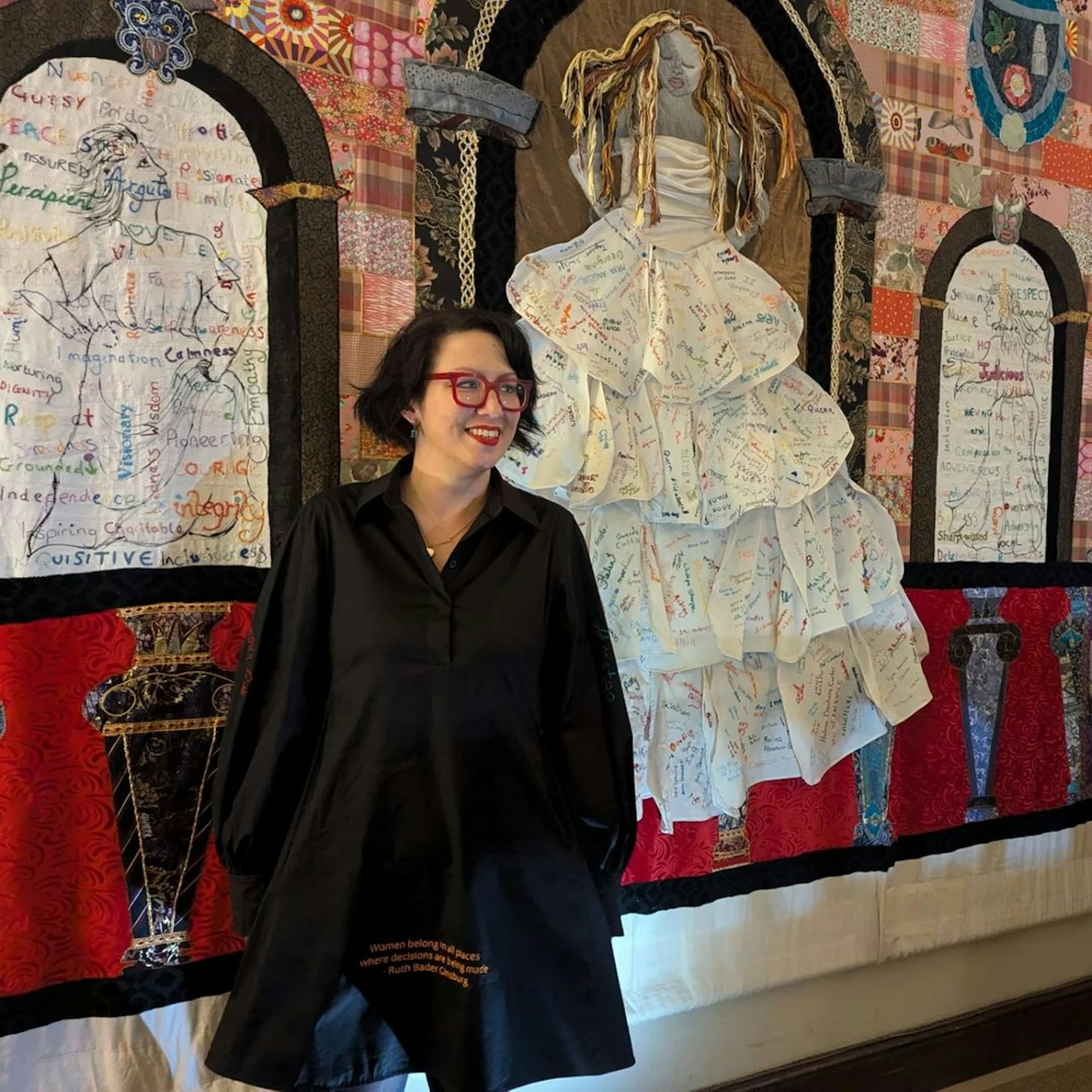 The artist in front of her artwork