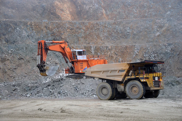 Large mining truck with loader working in the background