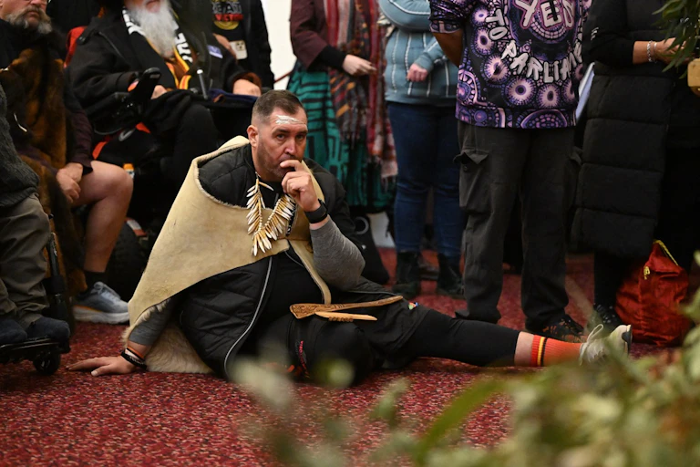 Yoorrook Justice Commission deputy chair Travis Lovett watches on at a Parliamentry reception at Melbourne's Parliament House.