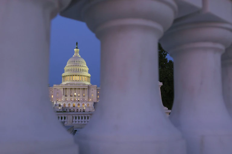 The U.S. Capitol Building is lit up at dusk.