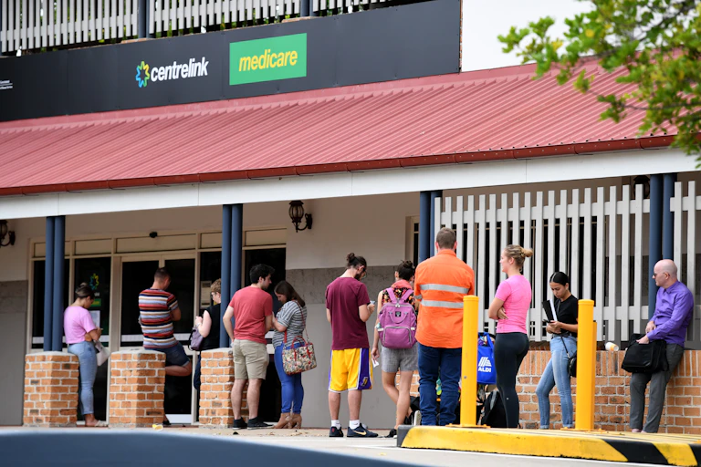 A queue of people outside a Centrelink/Medicare office