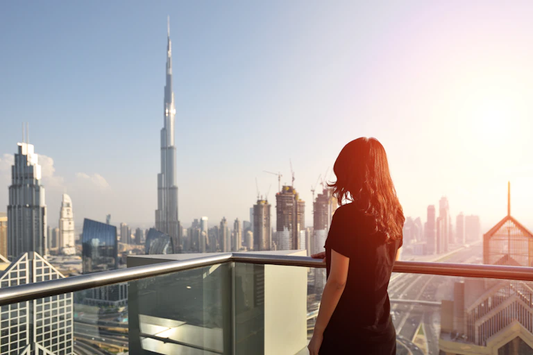 A woman overlooking the Dubai skyline.
