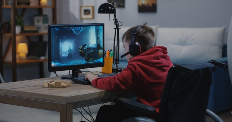 The web international comes with dangers – but in addition friendships and independence for younger other people with disabilities 1 Boy with wheelchair gaming on computer