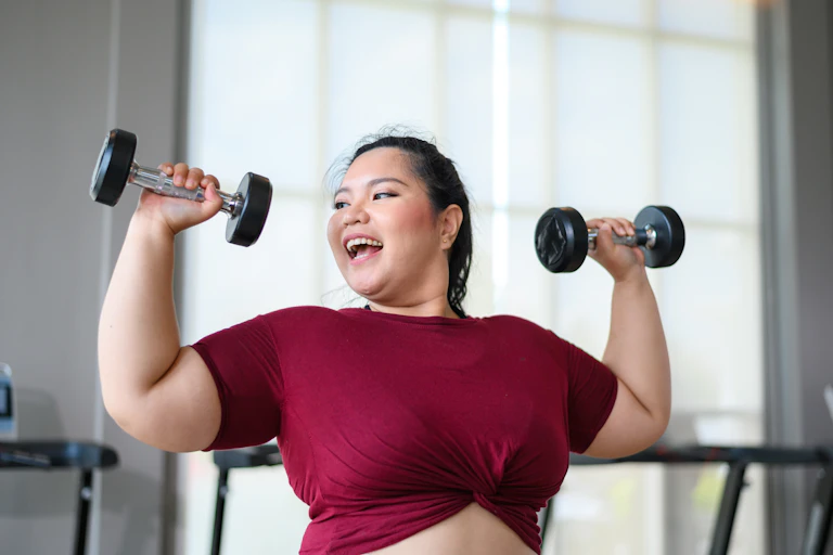 Woman enjoying working out with hand weights