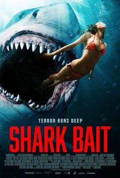 A shark closes in on a woman in a bikini.