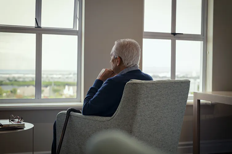 Rear view of a senior man in an armchair.