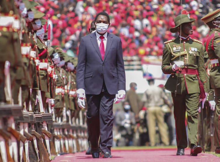 Zambia going through a democratic crossroads because it enters a contemporary constitutional disaster 1 Hakainde Hichilema inspecting a guard of honour during his inauguration ceremony.