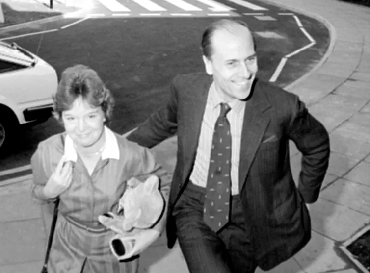 Black and white photo of the smiling Tebbits walking