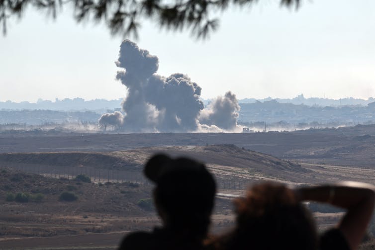 Israeli troops watch airstrikes on the Palestinian town of Beit Hanoun in the Gaza Strip.