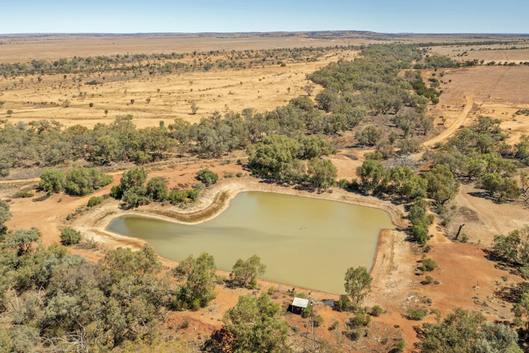 Dam in dried-out rural landscape.