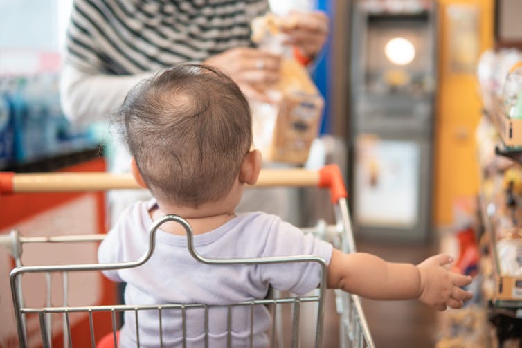 Parent with baby in supermarket