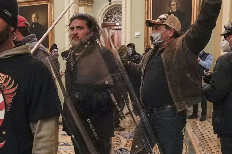 a bearded man in the u.s. capitol with others around him