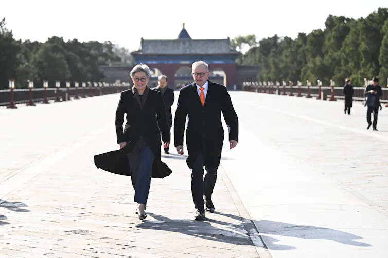 Prime Minister Anthony Albanese and Fopreign Minister Penny Wong walking outside the Temple of Heaven in Beijing