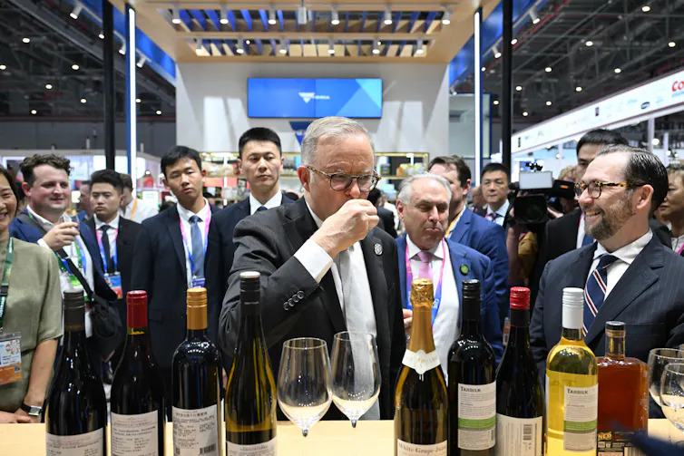 Prime Minister Anthony Albanese sipping a drink at a China trade fair