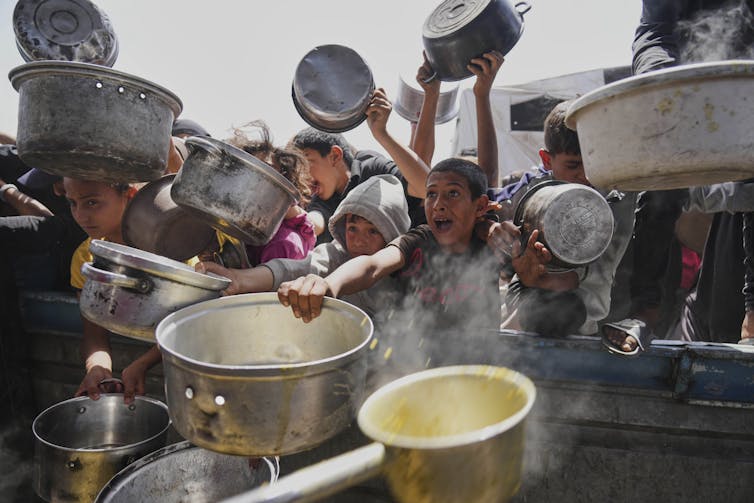 Starving Palestinian children with empty bowls in Gaza