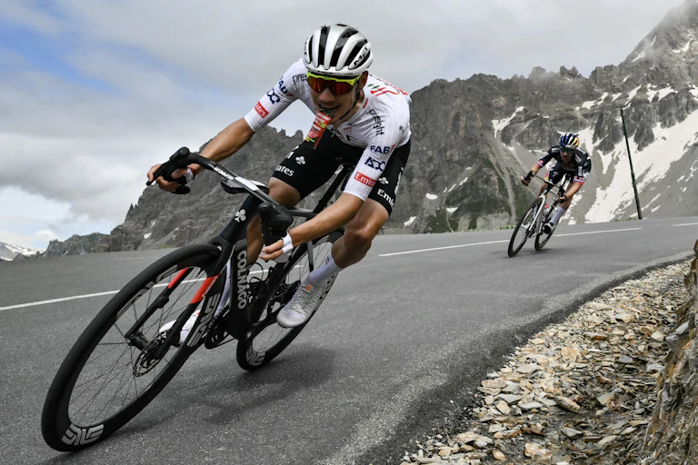Joao Almeida and Primoz Roglic descend down a hill during the 2024 Tour de France.
