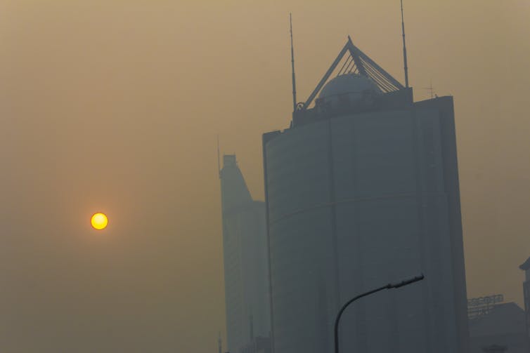 yellow smoggy sky, yellow sun and building