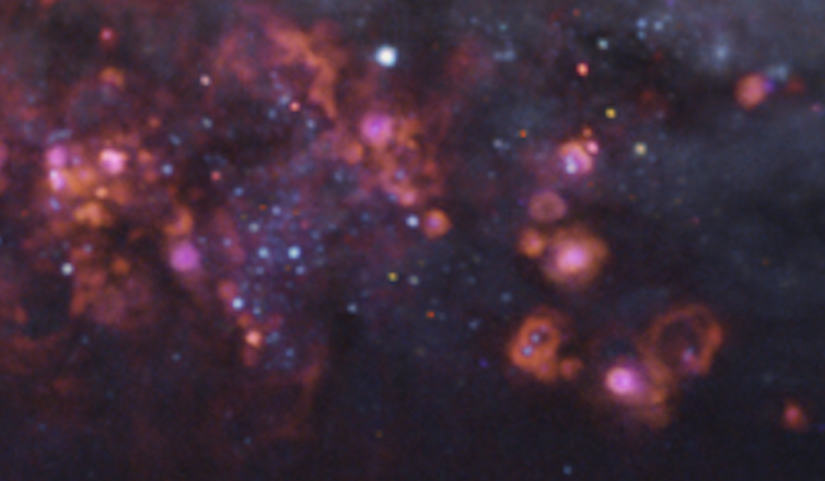 Clouds of gas punctuated by bright dots which represent stars.