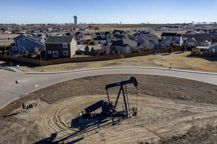 An oil rig sits across the street from a residential neighborhood in Frederick, Colorado.