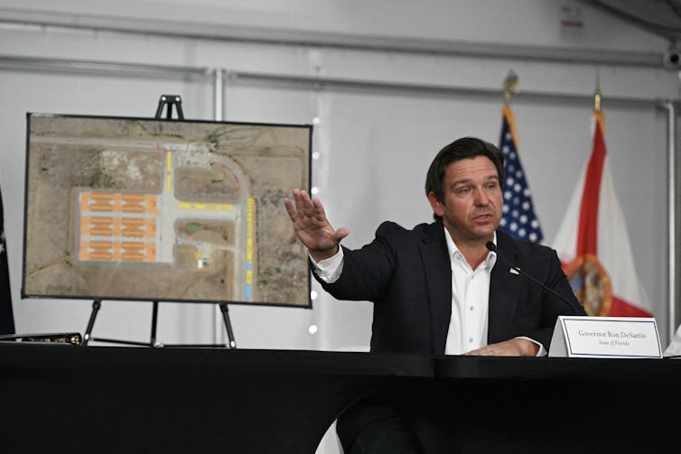 Florida Gov. Ron DeSantis speaking into a microphone