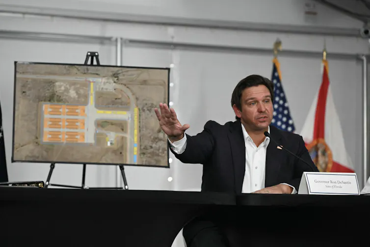 Florida Gov. Ron DeSantis speaking into a microphone
