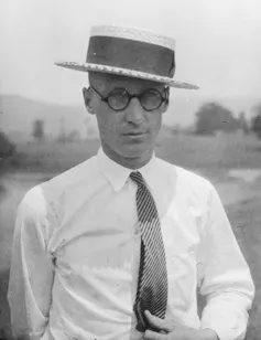 Black and white portrait of a man in a hat.