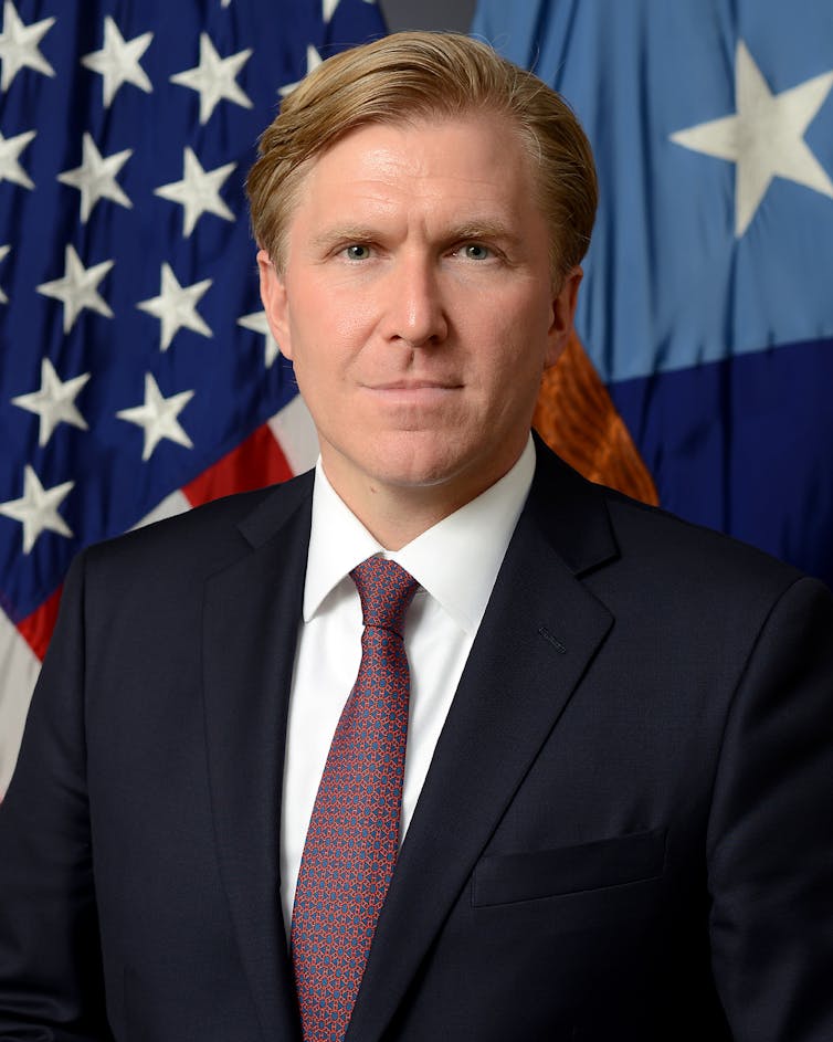 US under-secretary of defence for policy Elbridge Colby standing before the stars and stripes.