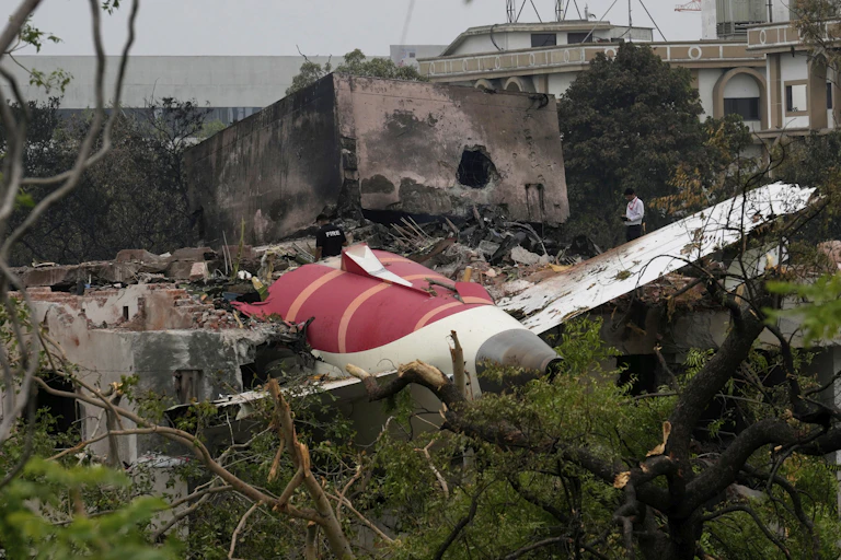 Part of wrecked plane lying in rubble