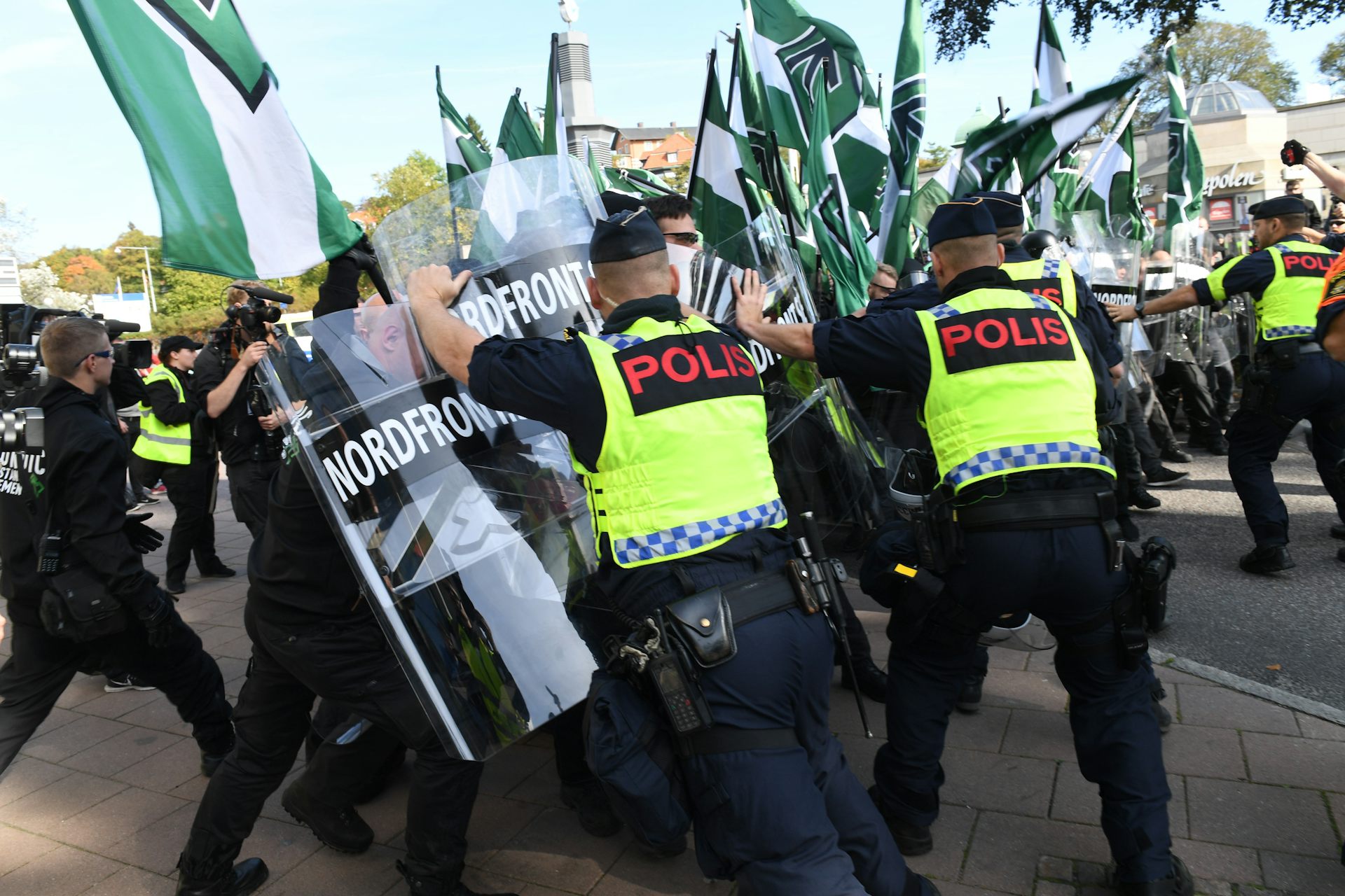 Nordic Resistance Movement demonstrators clash with police officers during a march.