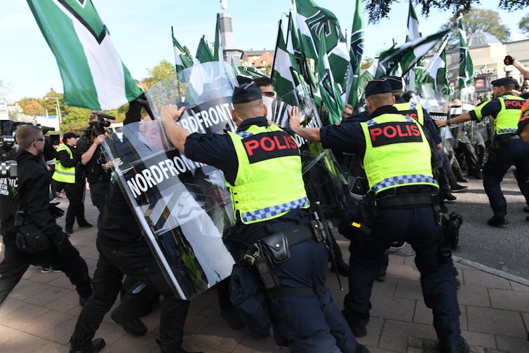 Russian Imperial Motion: how a far-right team outlawed through the United Kingdom is spreading terror throughout Europe 2 Nordic Resistance Movement demonstrators clash with police officers during a march.