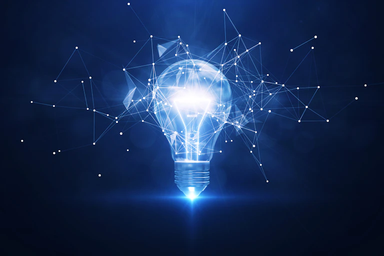 A brightly glowing bulb against a dark blue background laced with interconnected points of light.