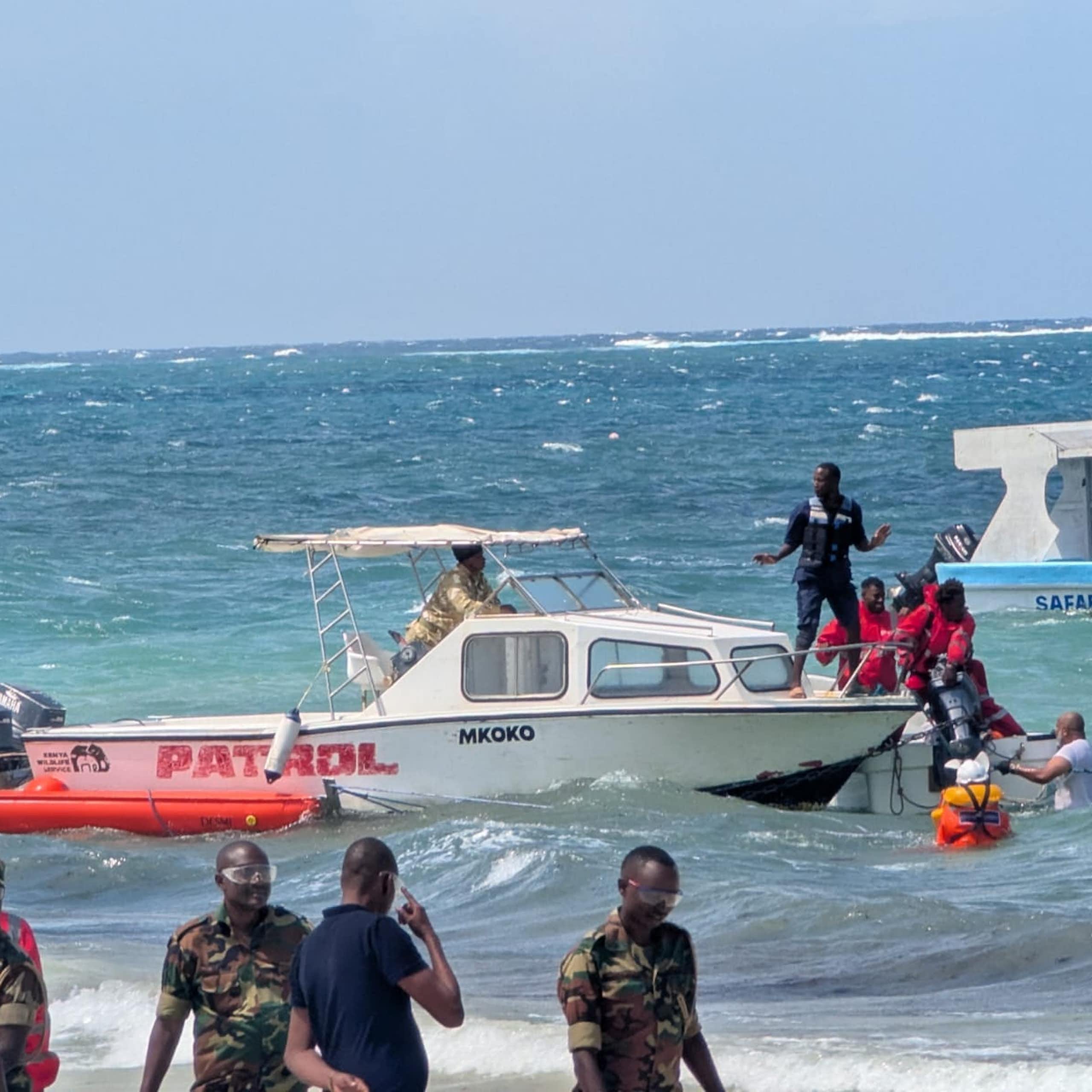 People wearing orange jackets and others get ready to react to an emergency preparation drill.