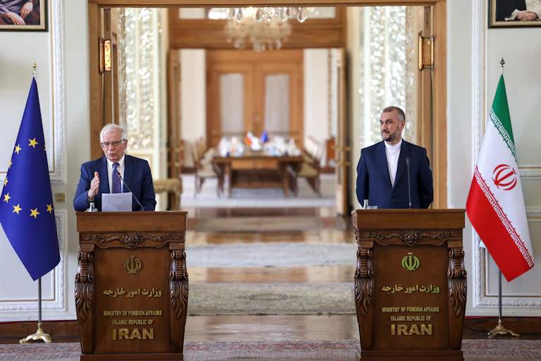 Two men standing next to a podium.