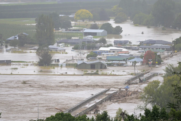 Flooded landscape with damaged buildings and roads
