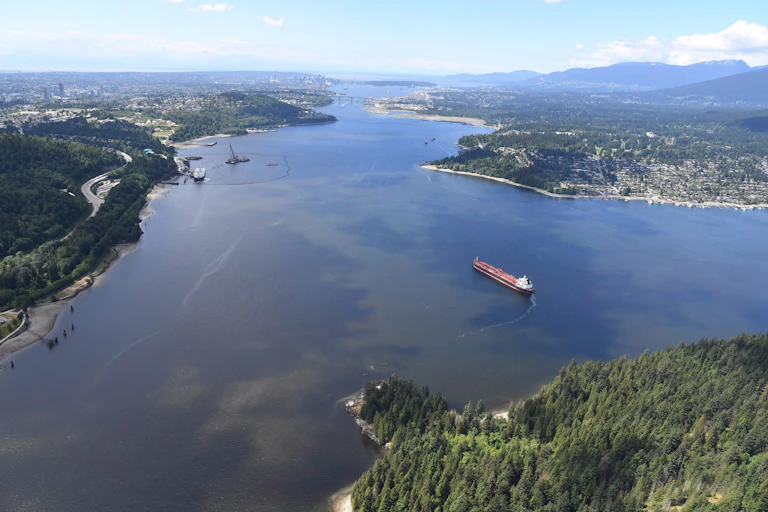 An aerial view of a tanker in a large fjord