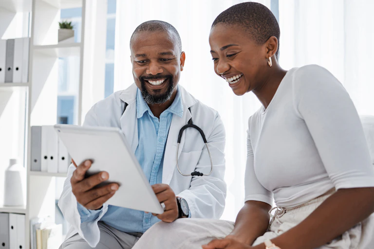 Smiling doctor and patient in discussion about notes