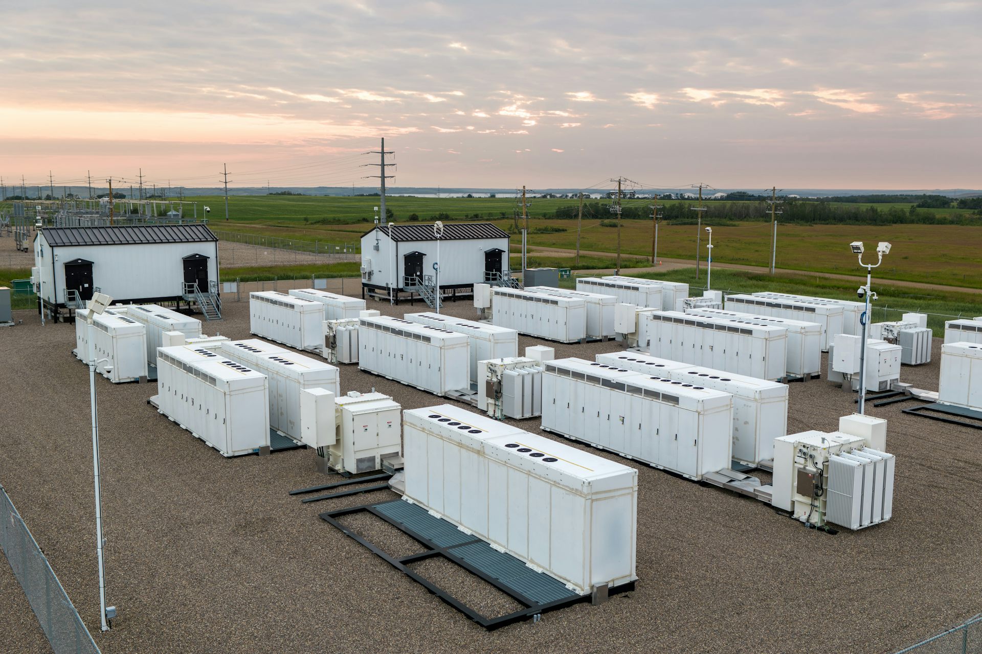 A fenced site filled with what look like white shipping containers.