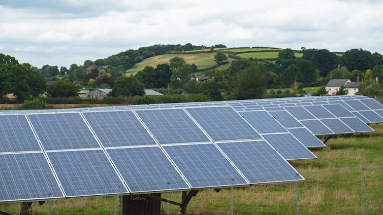 Rows of solar panels in a rural area.