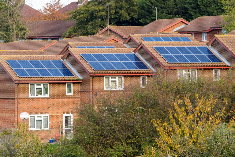 A row of houses with rooftop solar panels.