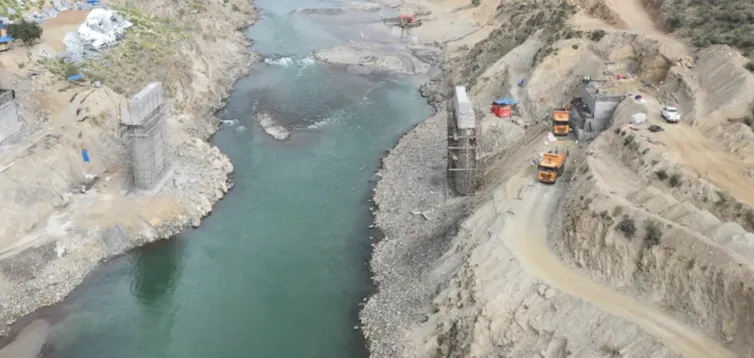 Two foundation stones are seen either side of a river.