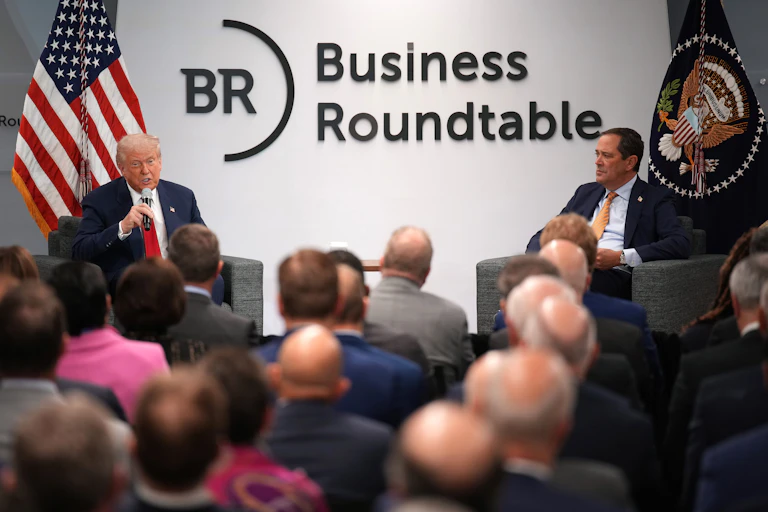 Donald Trump and Cisco Systems CEO Chuck Robbins sit before an audience at the Business Roundtable headquarters in Washington D.C.