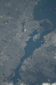 A satellite image of a waterway surrounded by a cityscape