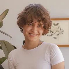 A young woman in a white t-shirt.