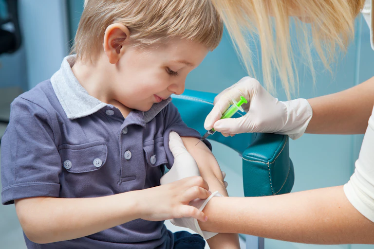 Smiling boy being vaccinated