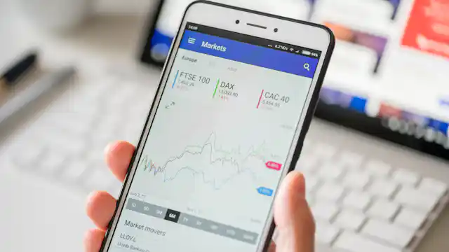 Mobile phone screen with stock market graphs