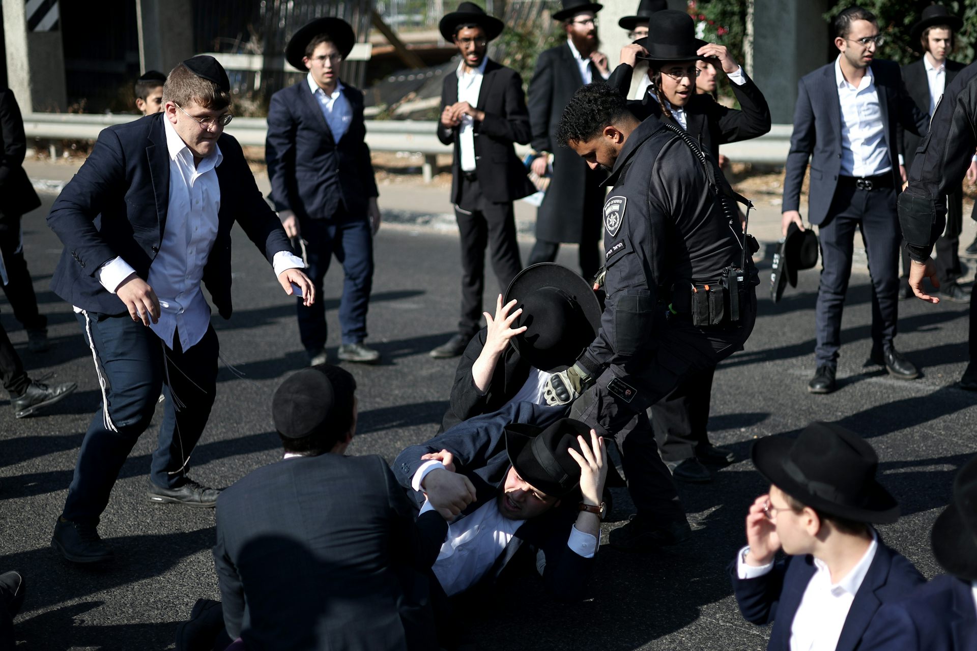 Israeli police officers clashing with ultra-Orthodox Jewish protesters.