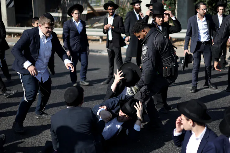 Netanyahu considering early election but can he convince people he’s winning the war? 1 Israeli police officers clashing with ultra-Orthodox Jewish protesters.
