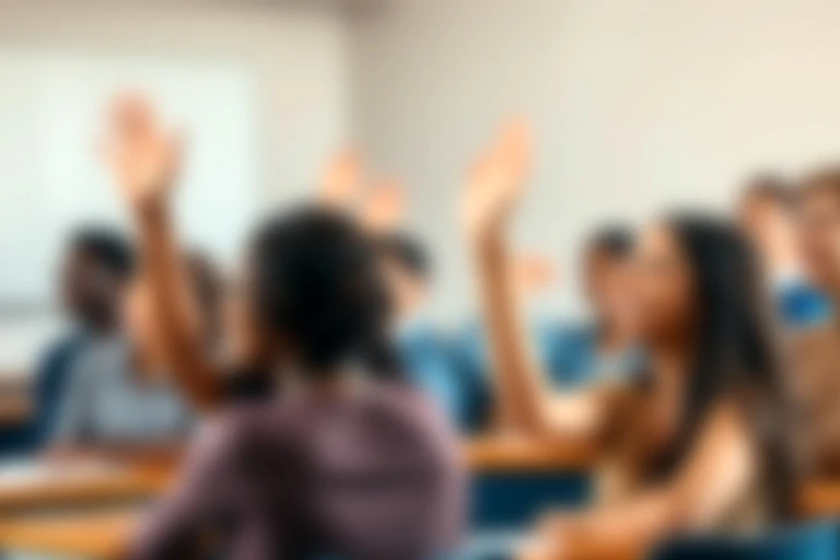 Blurred image of pupils raising hands in class