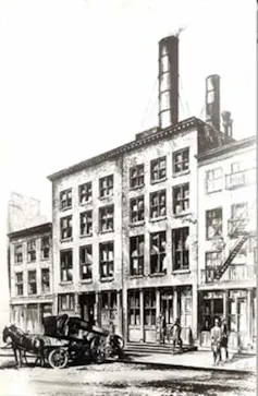 Sketch of a four-story city building with three tall smokestacks